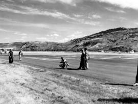 [Film crew on runway preparing to film water bombers at Kamloops Airport]