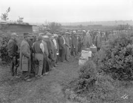 Distribution of food by Rev. Andrew Roddan of First United Church, to unemployed at City dump