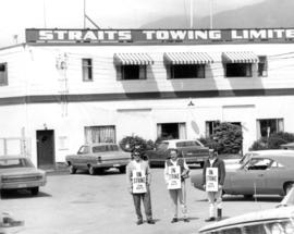 Three tow boat operators on strike in front of Straits Towing Limited