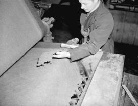 [Man checking peat at] B.C. Peat plant