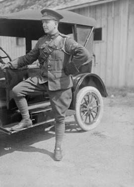 [A man in military uniform next to a car, 68th C.F.A.]