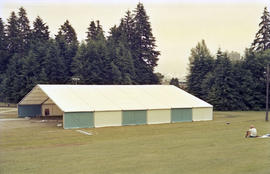 Workers installing light blue and white event tent at Stanley Park