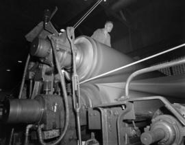 [A man operating a] paper machine [at] Pacific Mills