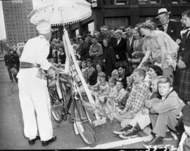 Clown with crowd at 1953 P.N.E. Opening Day Parade