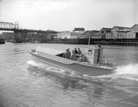 Men on barge near docks at Granville Island