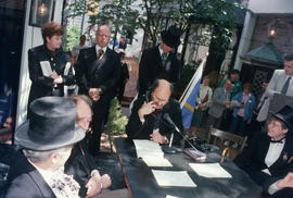 Mike Harcourt speaking into telephone during reenactment of Vancouver's first City Council meetin...