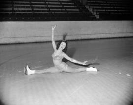 [Figure skater doing the splits on the ice during a practice for the Rotary Club Ice Carnival]