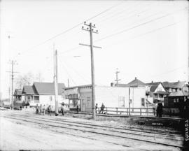 [Men erecting power pole at Commercial Drive and Eleventh Avenue]