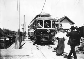 [Passengers board the Lulu Island-Eburne Interurban tram on the foot of Granville Street at False...