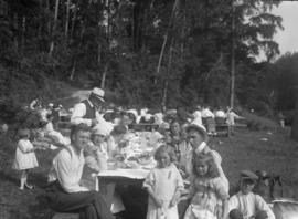 Hawick picnic [group eating at long table]