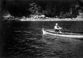 Reverend Andrew Roddan in rowboat at Camp Fircom