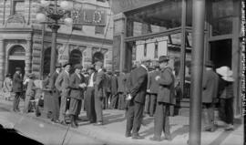 [Men assembled outside the office of the World newspaper, at Hastings and Richards Streets]