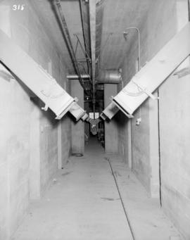 Looking north in basement of bin #2 showing discharge of chutes, lump crusher & heating syste...