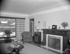 [Interior view of a house showing the living room with fireplace]