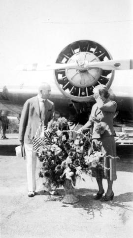 Sea Island airport - United Airlines stewardess Dorethea Bow hands flowers to L.D.T. [Mayor L.D. ...