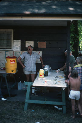 [Man at Pacific National Exhibition sports camp snack table]