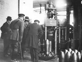 King George inspects a hydraulic press in a munitions factory