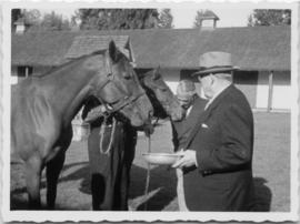 Eric W. Hamber and Clarence Wallace with horses at Minnekhada stables