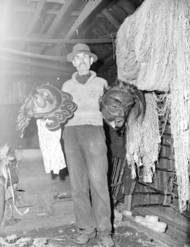 [Harry James holding two masks]