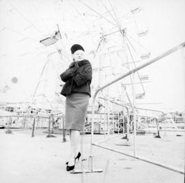 Woman next to Ferris wheel in P.N.E. Playland