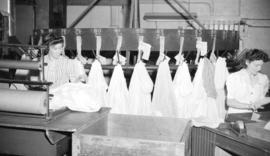 [Women marking bundles of clothes at Nelson's Laundry'