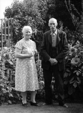 Mr. and Mrs. James L. Quiney [in the garden at] 4916 Union Street, Burnaby