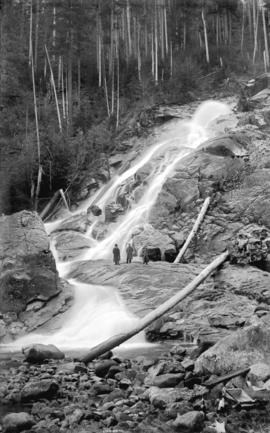 [Three men standing by Granite Falls, Indian Arm]