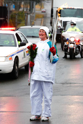 New Day 27 Torchbearer 23 Lynn Kearns receives roases and a metal from her grandchildren after ru...