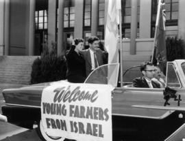 Israeli young farmer guests Edna Shur and Ilan Bender in car by P.N.E. Livestock building