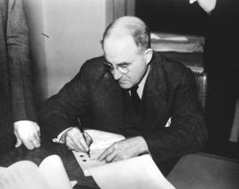 [Major J.S. Matthews signs a document to appoint responsibility for the Archives' holdings to a b...