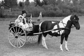 Children riding in a curricle guided by a groom at Minnekhada