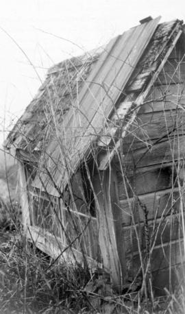 [Ancient Musqueam above-ground burial hut with modern windows]