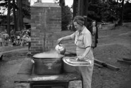 [Mrs. E. Shields cooking at the Housewives' League Annual Picnic]