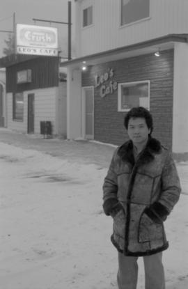 Young man standing at the site of Gordon Yee's café on Centre Street in Naicam, Saskatchewan