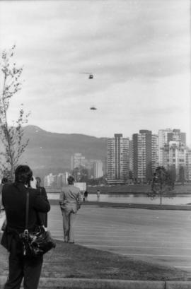 Man photographing helicopter from parking lot