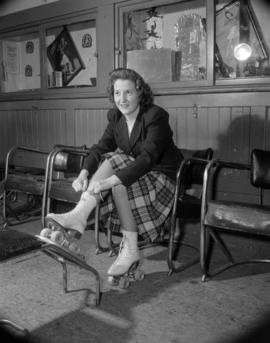 [Woman putting on roller skates at the Vancouver Roller Skating Club]