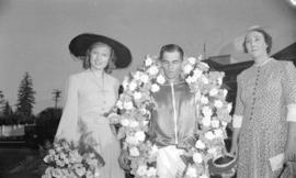 [Miss. Anna Neagle with winning jockey at Hastings Park race track]