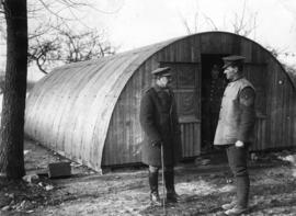 [Soldiers in front of a 'Nissen' hut in winter]
