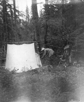 [A men entering a tent in a logging camp]