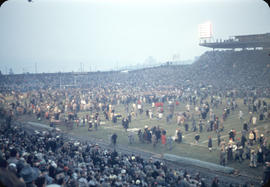 End of 43rd Grey Cup game at Empire Stadium, crowd on playing field