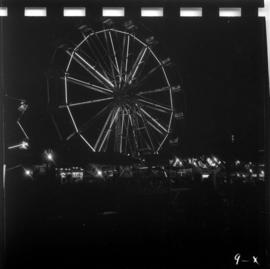 Illuminated Ferris wheel in P.N.E. Gayway at night