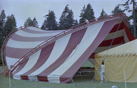 Workers installing red and white striped canopy at Stanley Park