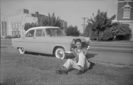 [Joseph Selsey posing in front of an automobile]