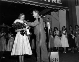 Glenda Sjoberg, winner of Miss P.N.E. 1955, receiving fur stole on Outdoor Theatre stage