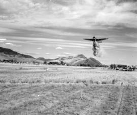 [Water bomber dropping water on a field near Kamloops]