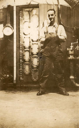 J. Perry in front of cast iron vacuum pans