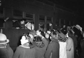 [Japanese Canadians on train waving goodbye to friends on platform in conjunction with forced rem...