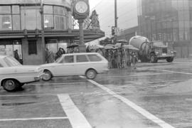 Pedestrians waiting at W. Georgia Street and Granville Street crosswalk