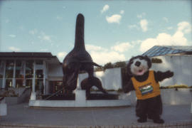 Tillicum beside Bill Reid orca sculpture at the Vancouver Aquarium