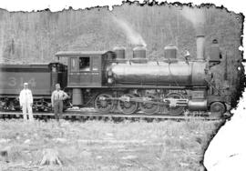 [Two men standing in front of C.P.R. engine number 314 at Field, B.C.]